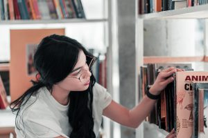 A woman looking at books.
