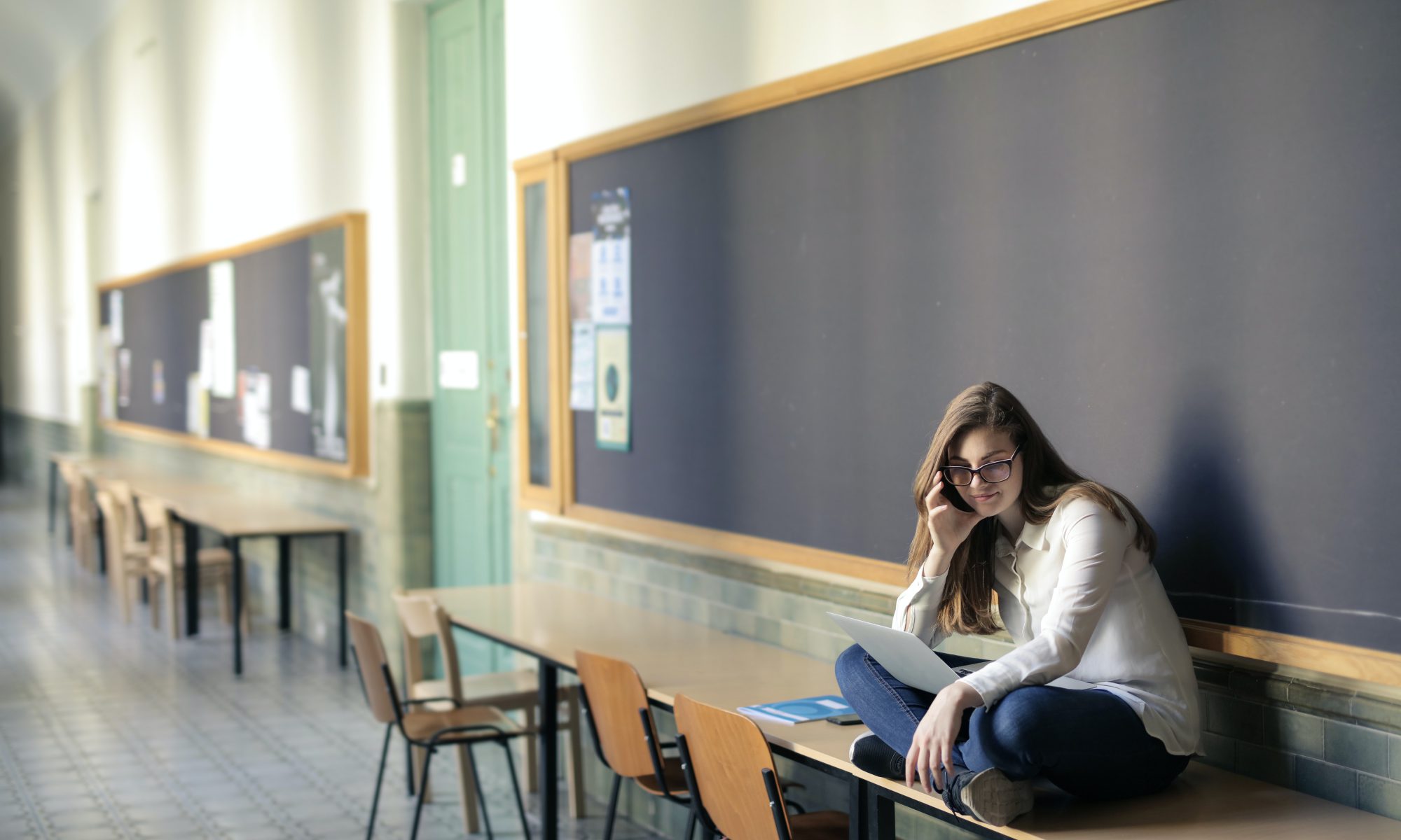 A woman sitting on a desk.