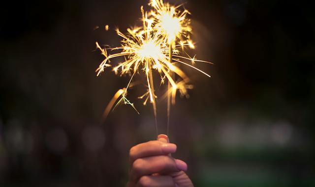 A person holding a sparkler.