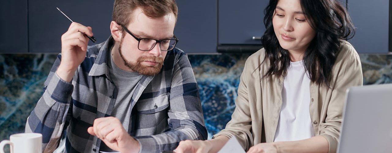 A man and a woman looking over documents.
