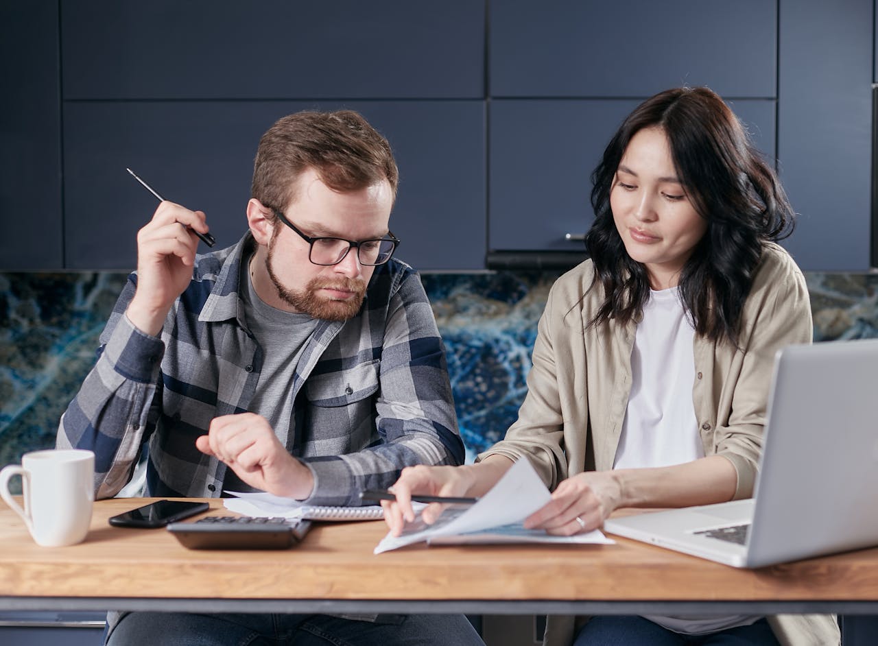 A man and a woman looking over documents.