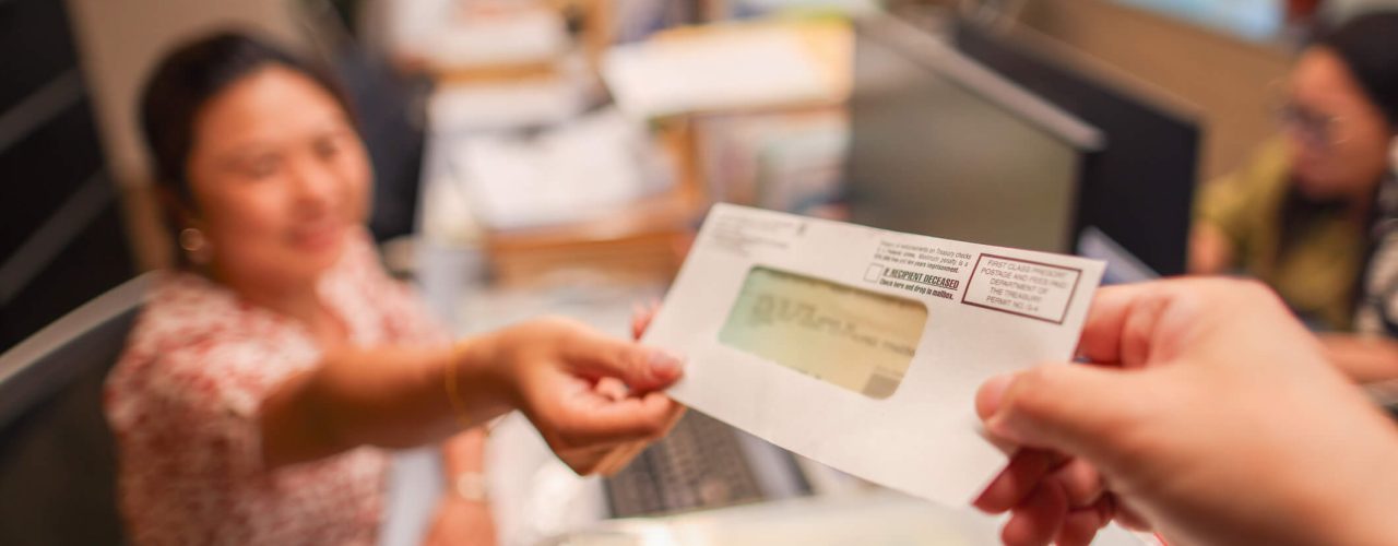 A woman receiving a tax refund check.