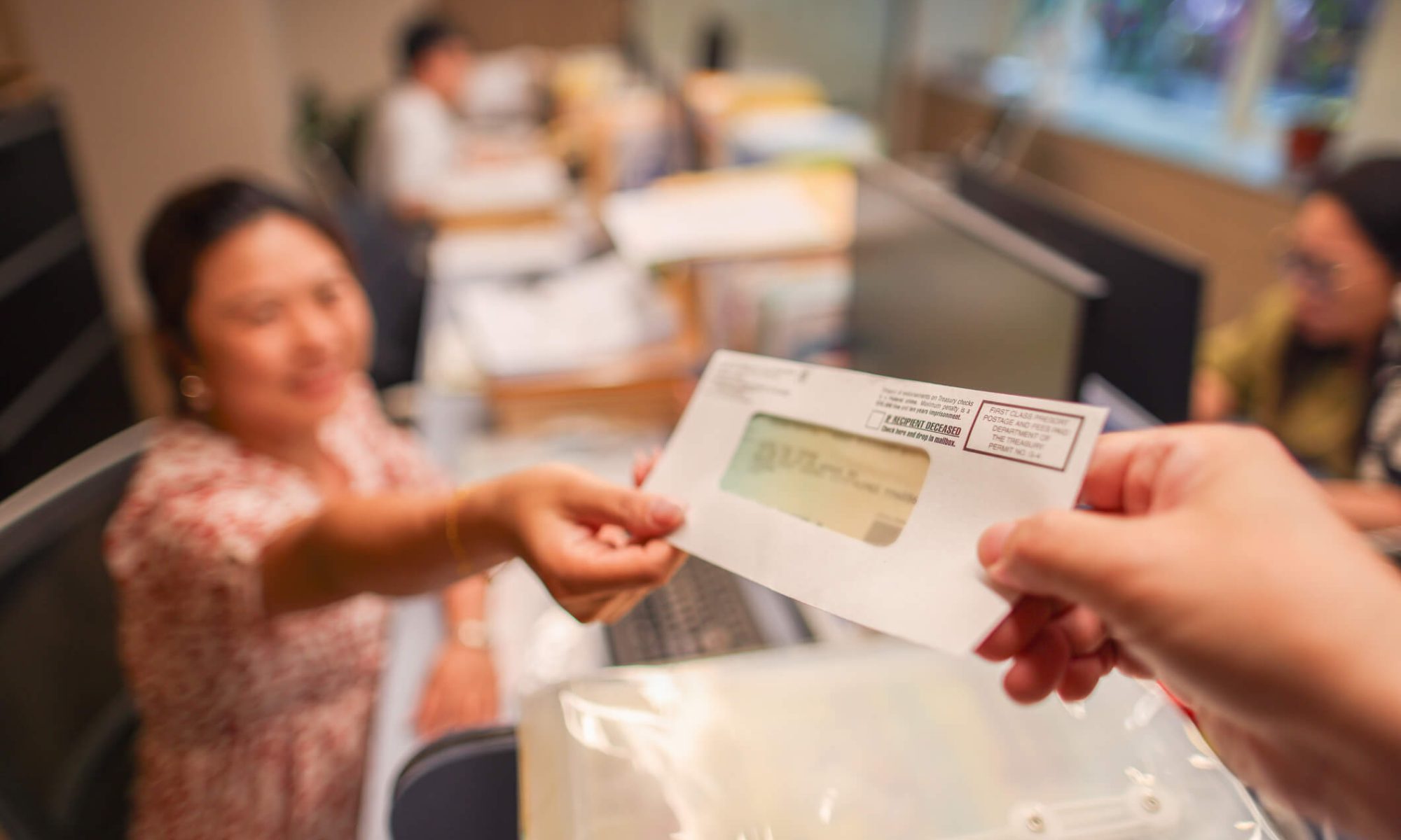 A woman receiving a tax refund check.