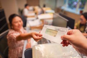 A woman receiving a tax refund check.